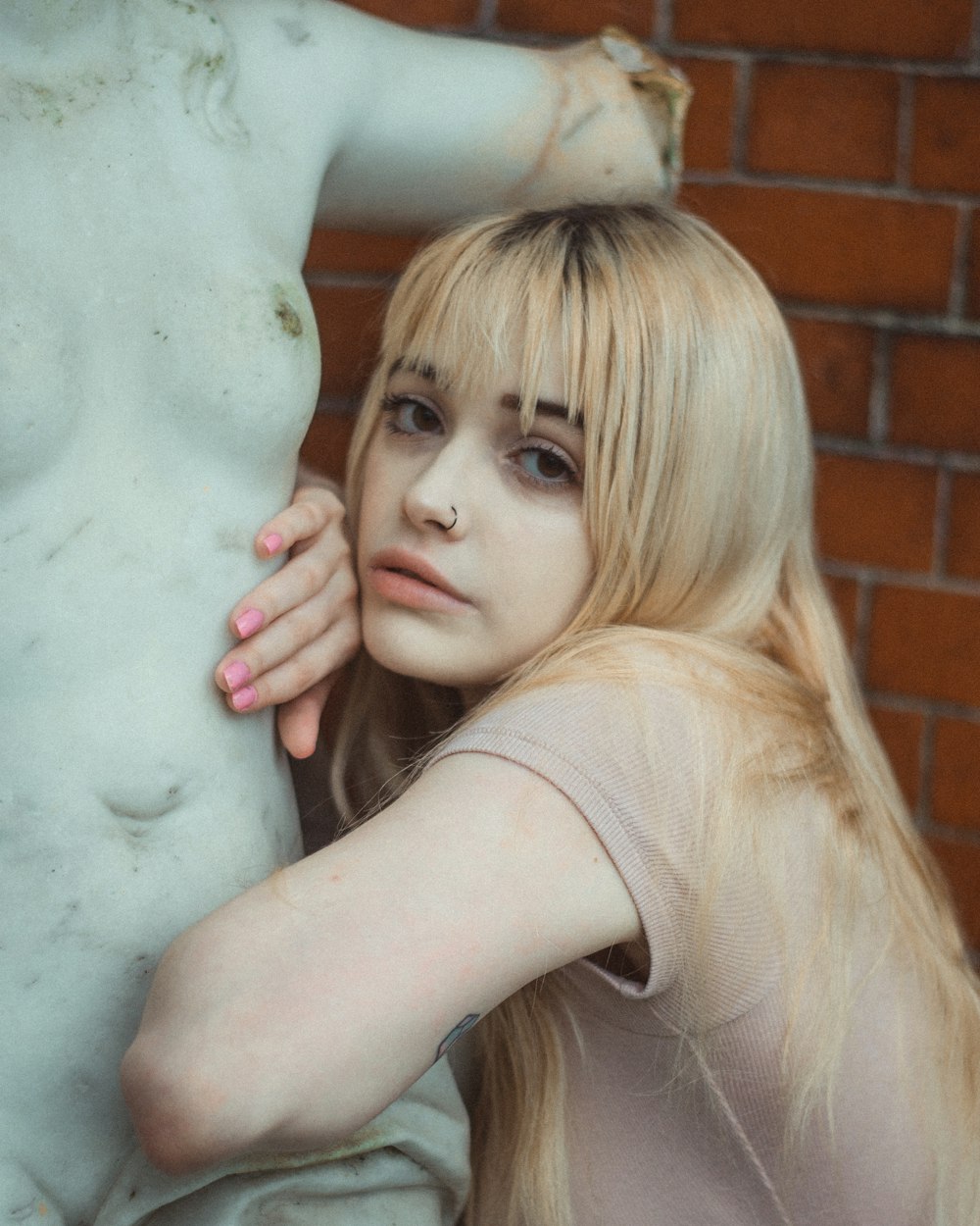 woman leaning on statue