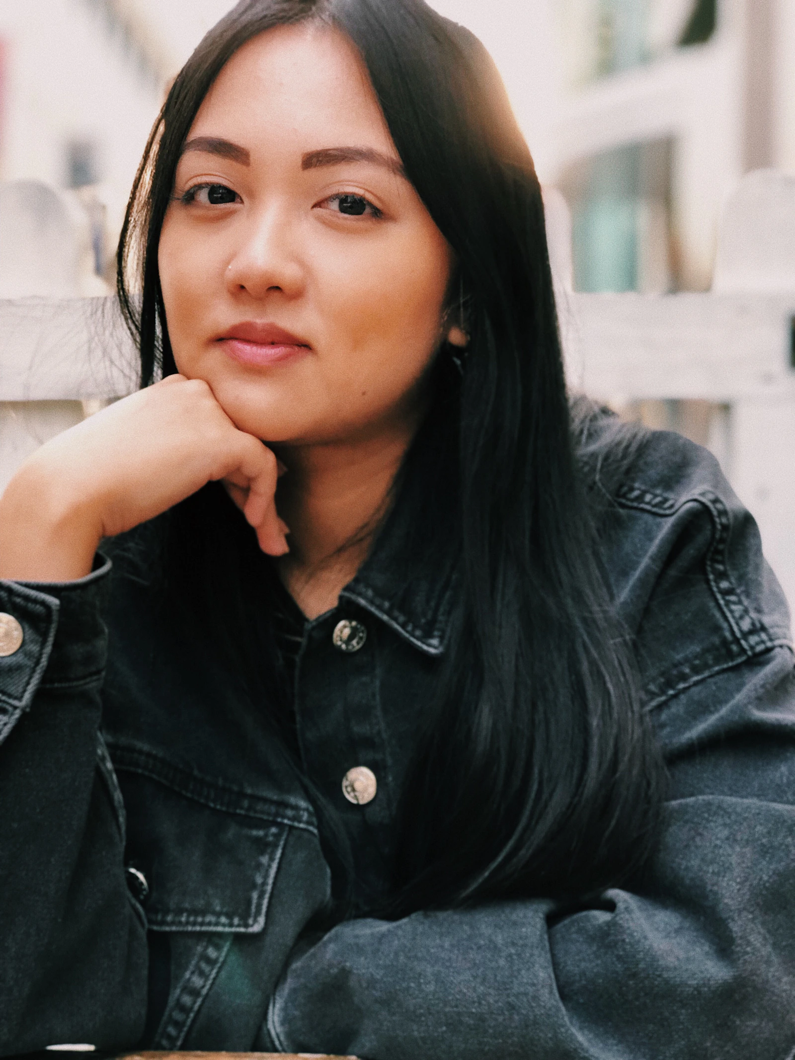 Person in a dark denim jacket