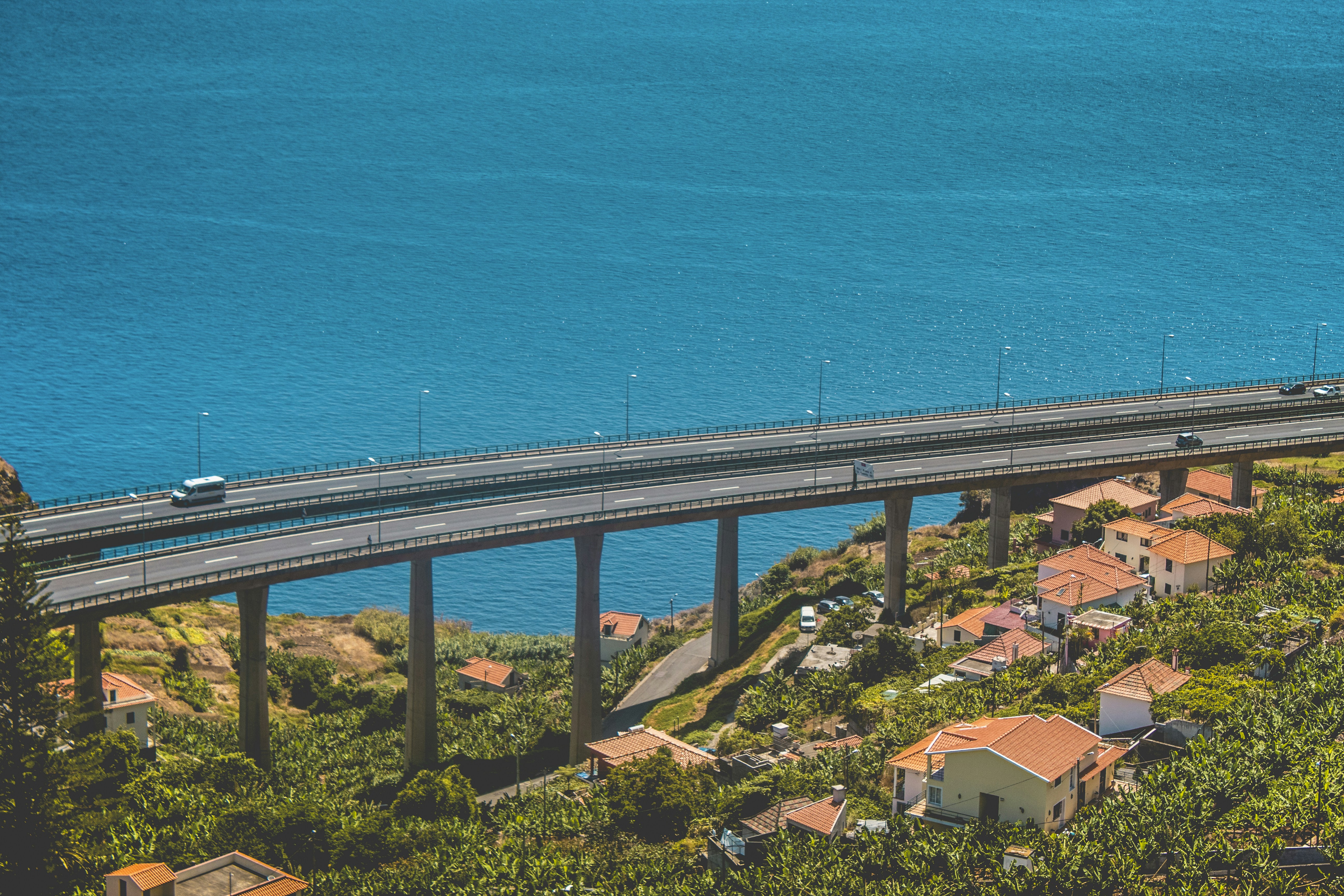 aerial photo of concrete bridge near body of water