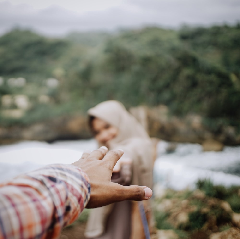 man and woman reaching hands