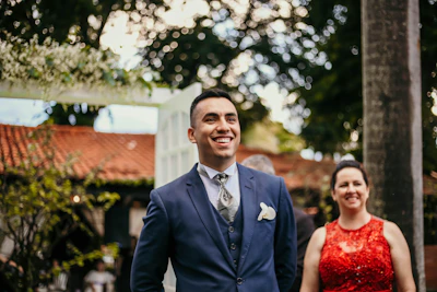 A friendly real estate agent discussing options with a happy couple outdoors.