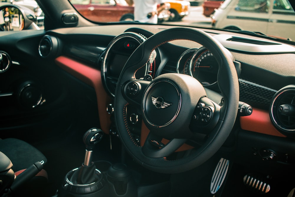 black Mini Cooper vehicle steering wheel in closeup shot