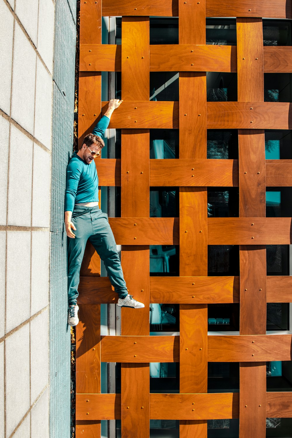 man standing near the brown wooden frame