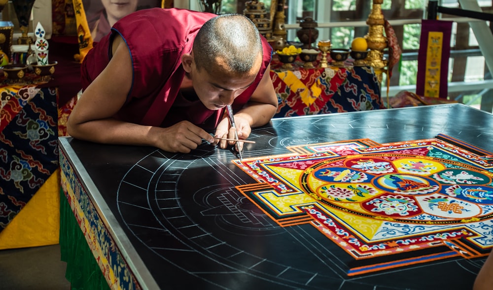 man leans on gaming table