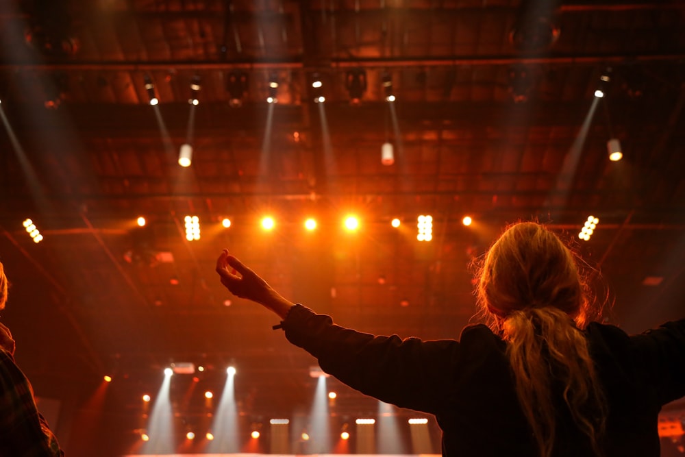 woman raising both hands