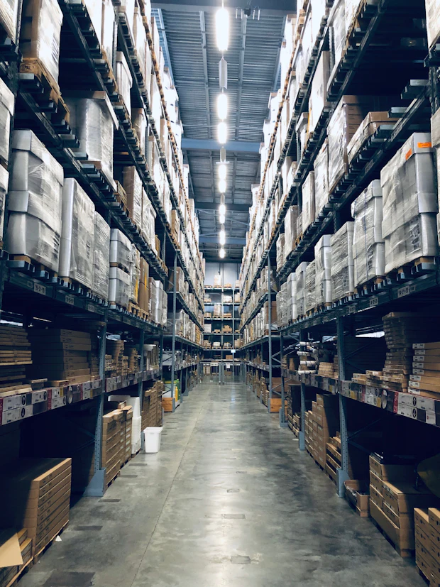 Warehouse aisle stacked with palletised freight ready for despatch