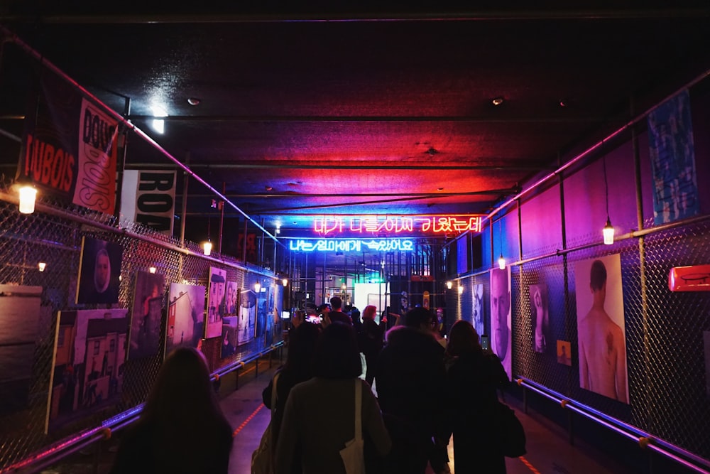 group of people walking under subway