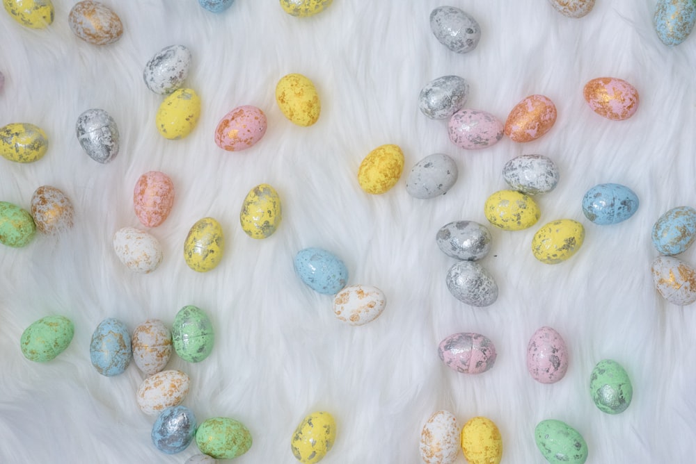 assorted-color Easter eggs on white textile