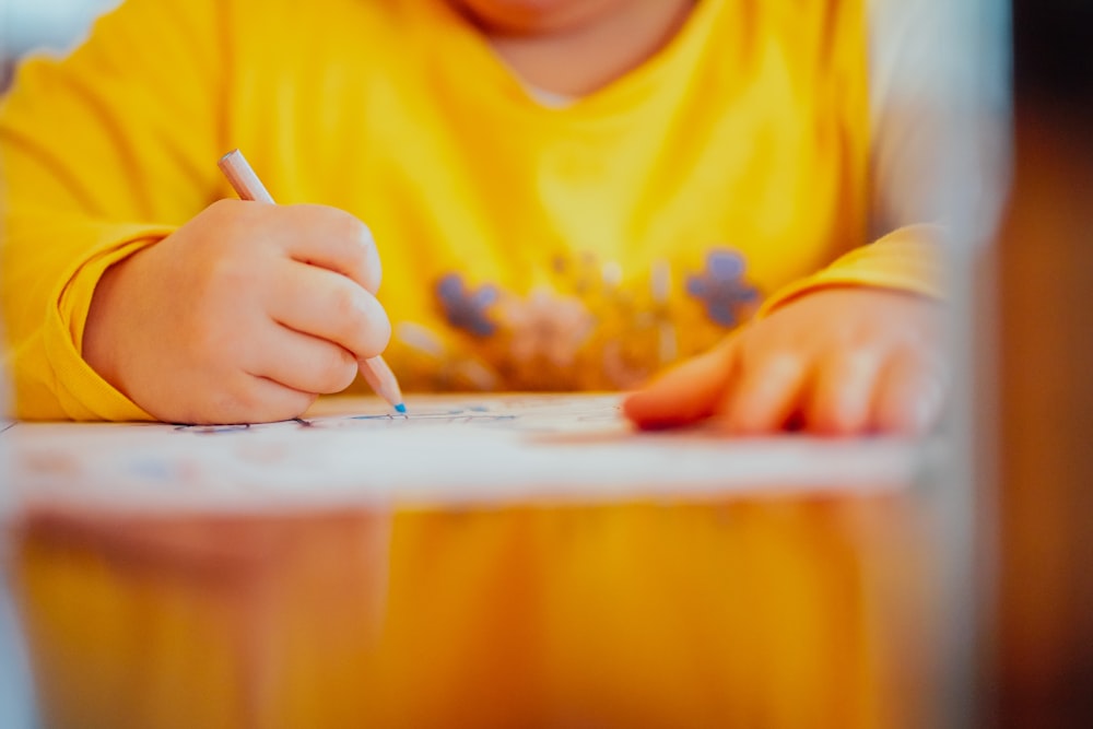 person sitting and writing don