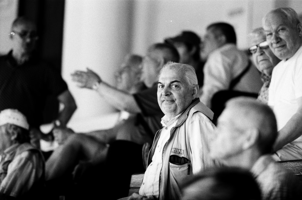 grayscale photography of sitting men