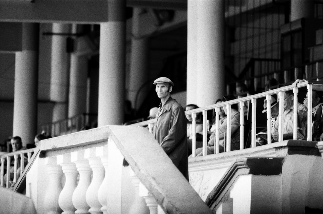 man standing near people sitting on chairs