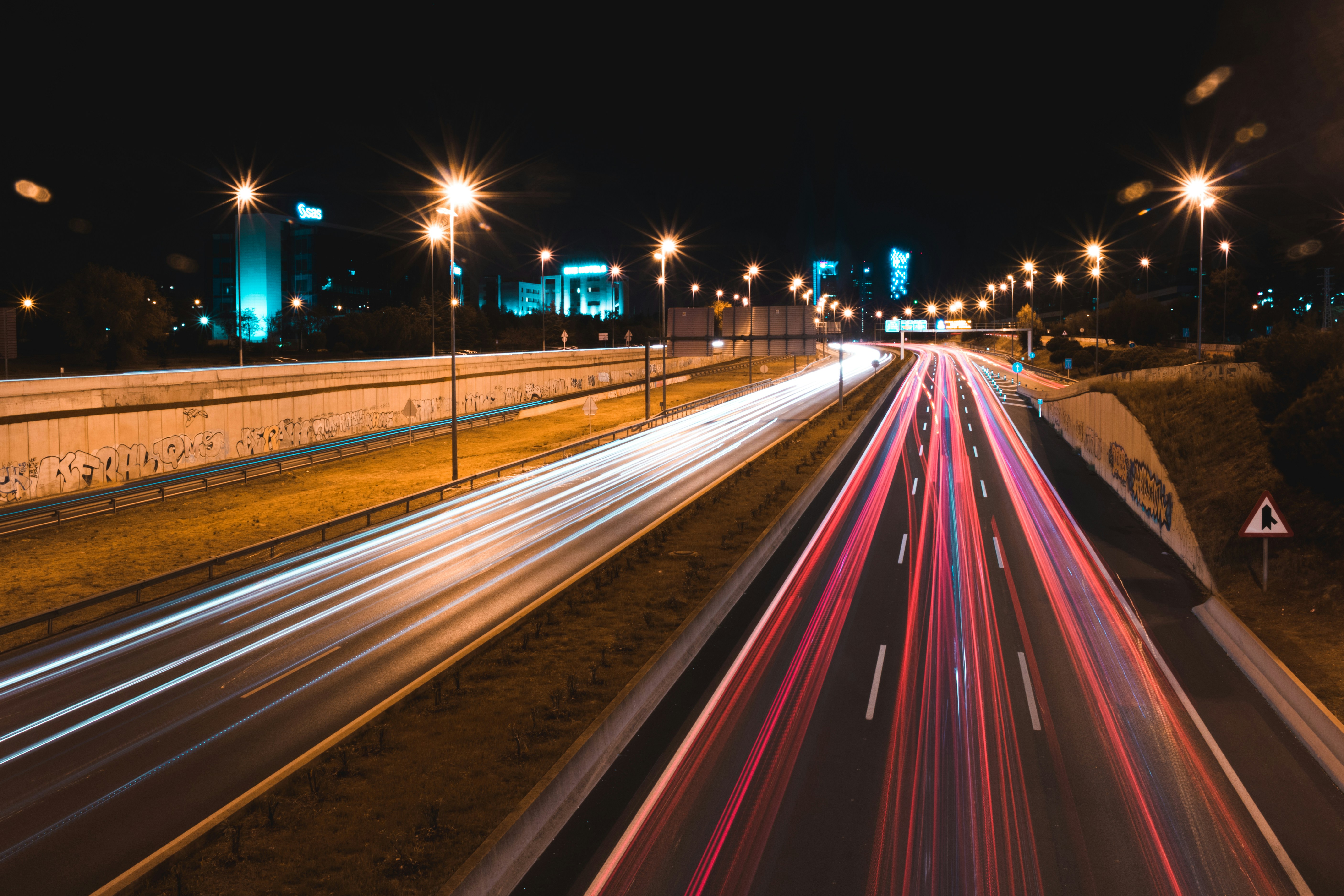 lighted cars passing highway