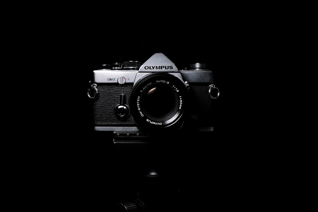 black and grey Olympus SLR film camera