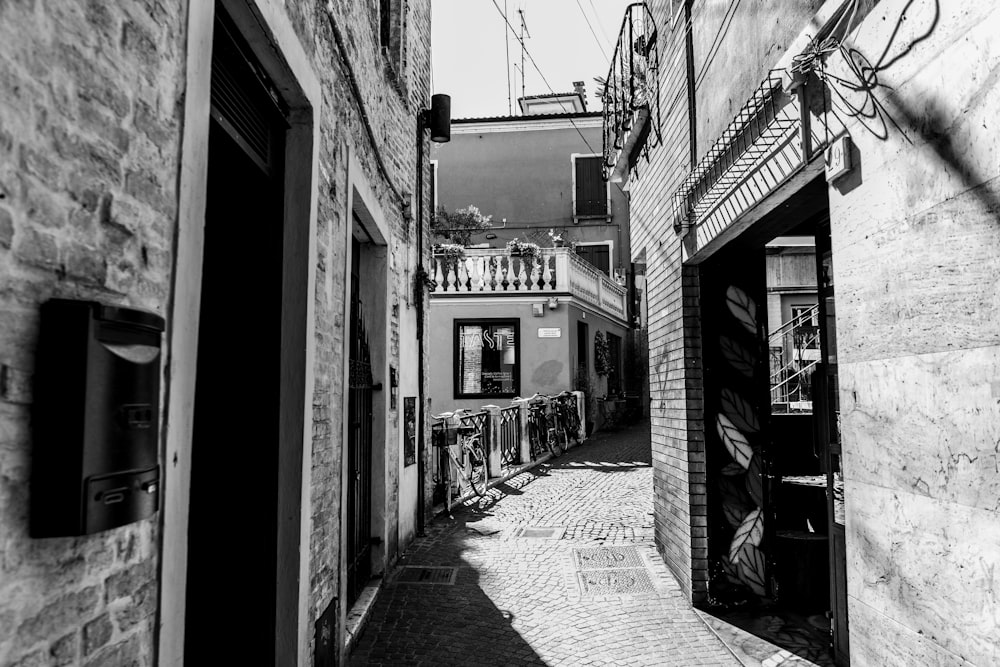grayscale photography of alley between buildings