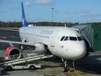 truck parked near commercial airplane on airport