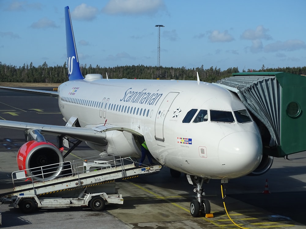 truck parked near commercial airplane on airport