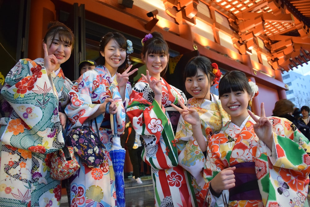 five women wearing oriental dresses