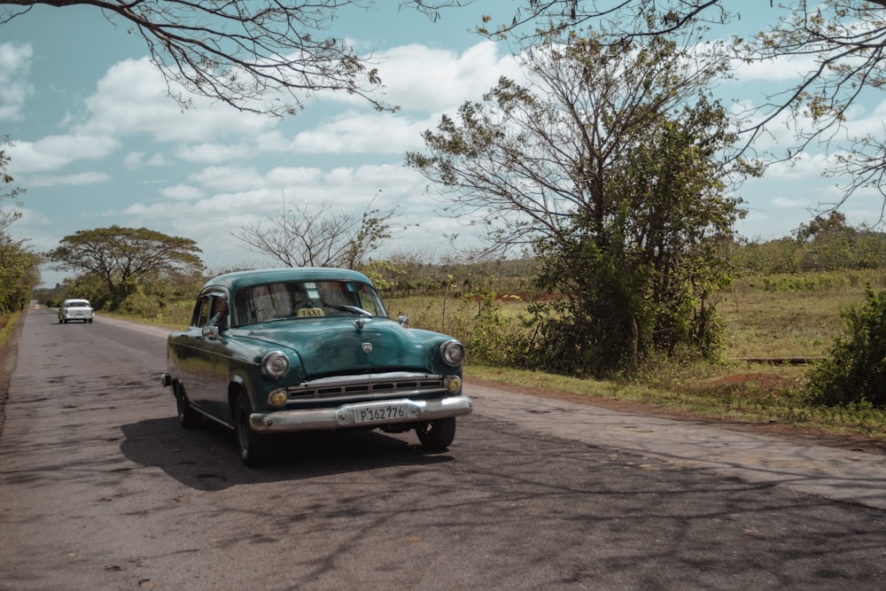 vintage green coupe on road