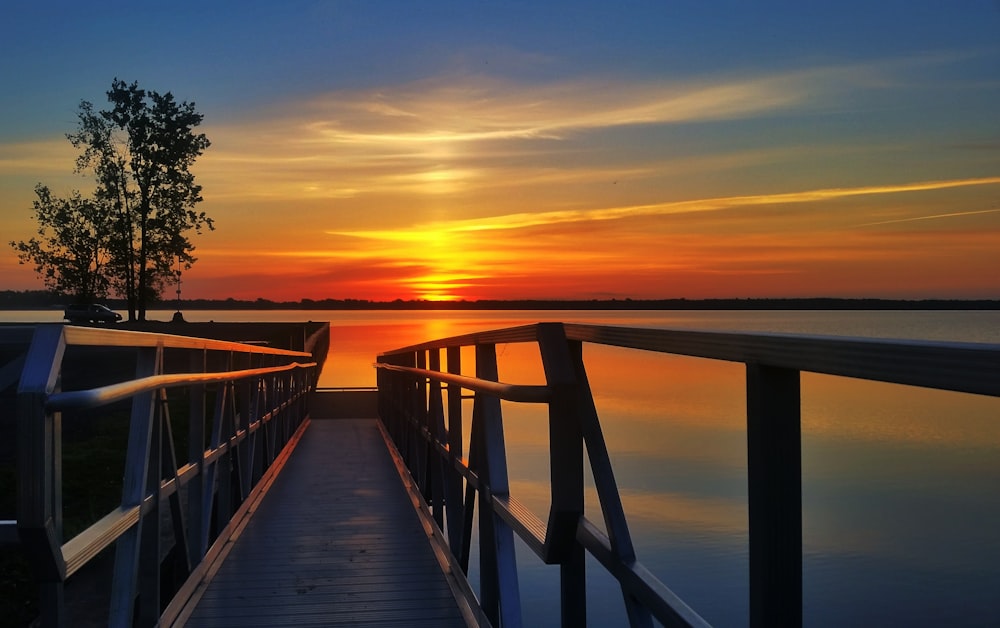 a wooden walkway leading to a body of water