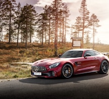 red Mercedes-Benz coupe on road