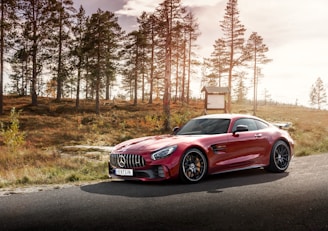 red Mercedes-Benz coupe on road