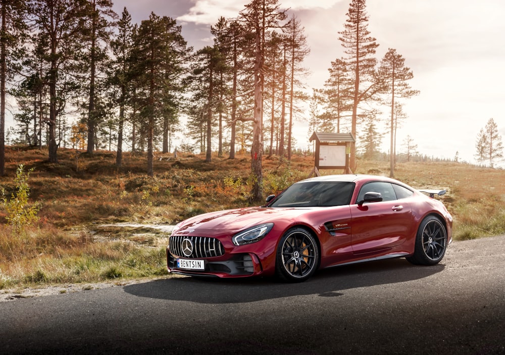 red Mercedes-Benz coupe on road