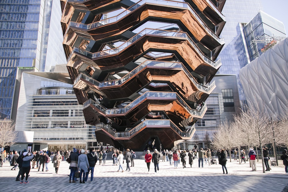 people on park below the giant sculpture