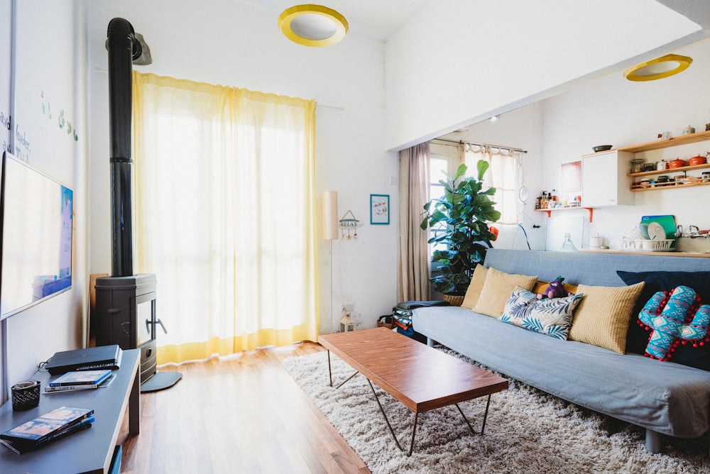 assorted-color throw pillows on armless futon in living room are of the house