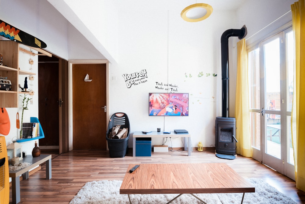 brown wooden coffee table near flat screen television