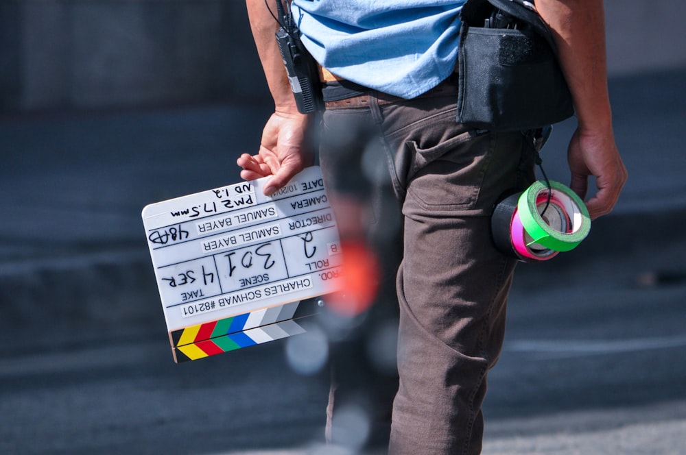 standing person holding clap board