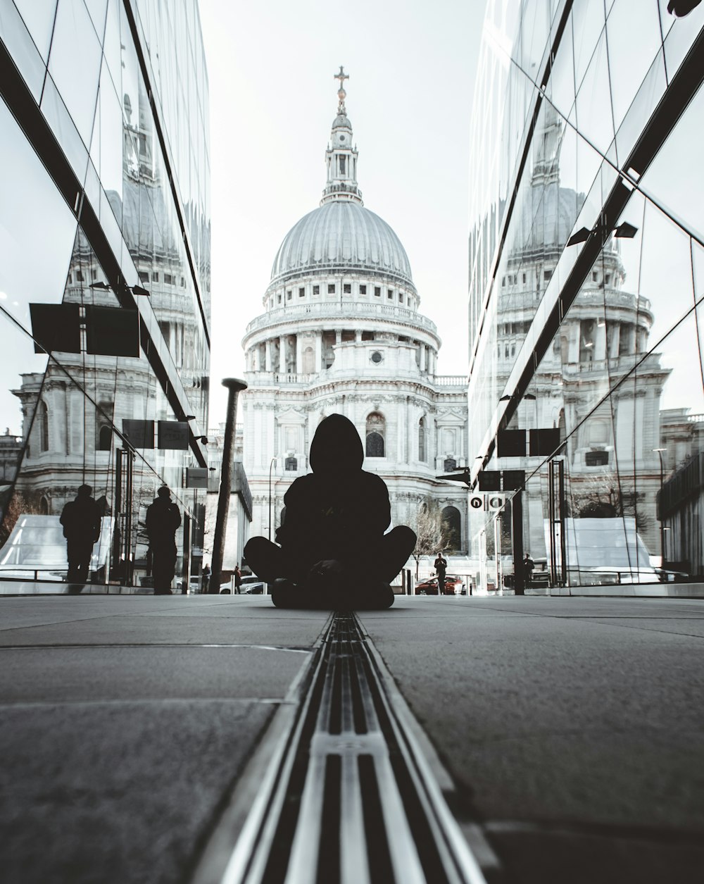 person sitting on road near dome building