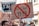 A protest scene with a crowd holding various signs, including one prominently displaying a sign with a red circle and line through 'Artikel 11-13'. Other signs in the background include messages about upload filters and internet freedom, conveyed in German. People appear engaged and concerned in an urban setting.