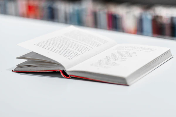 An open hardcover book on a white table
