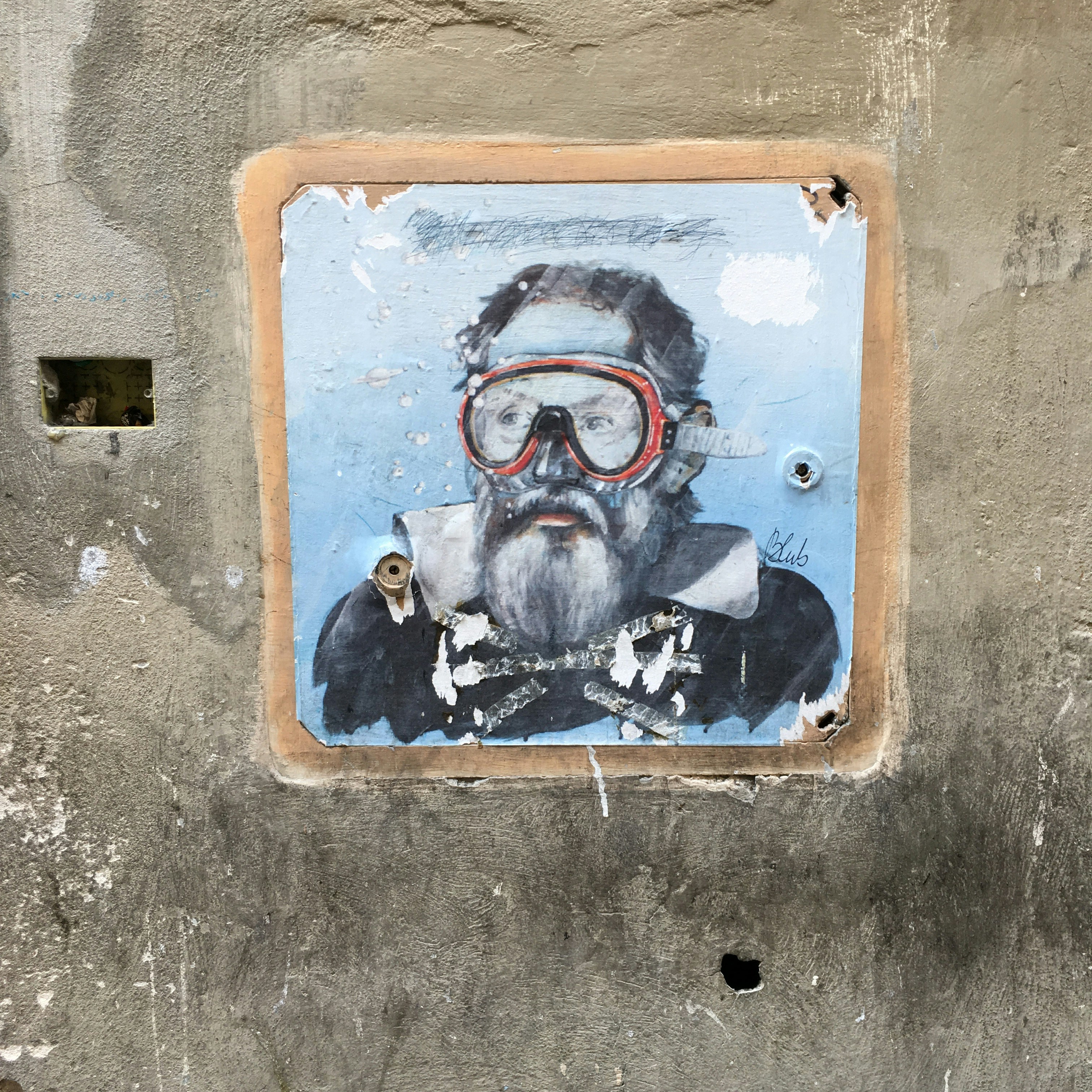 wheatpaste art poster showing a man underwater wearing goggles