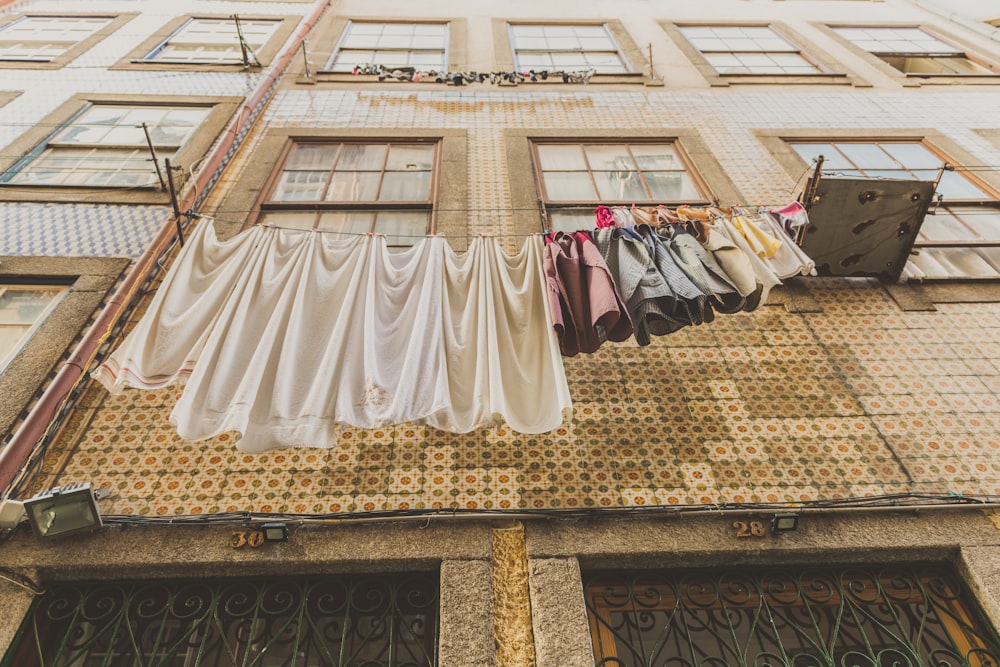 assorted clothes hanged on wire