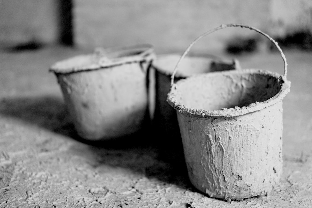 three gray buckets, under construction