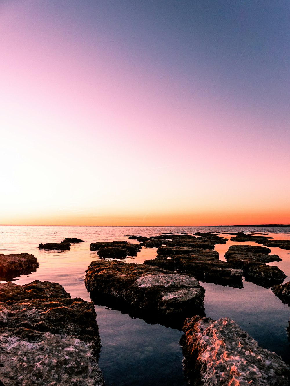 rocky island beside beach