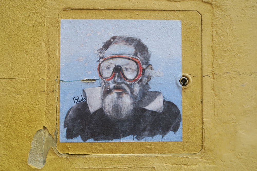 man wearing goggles painting