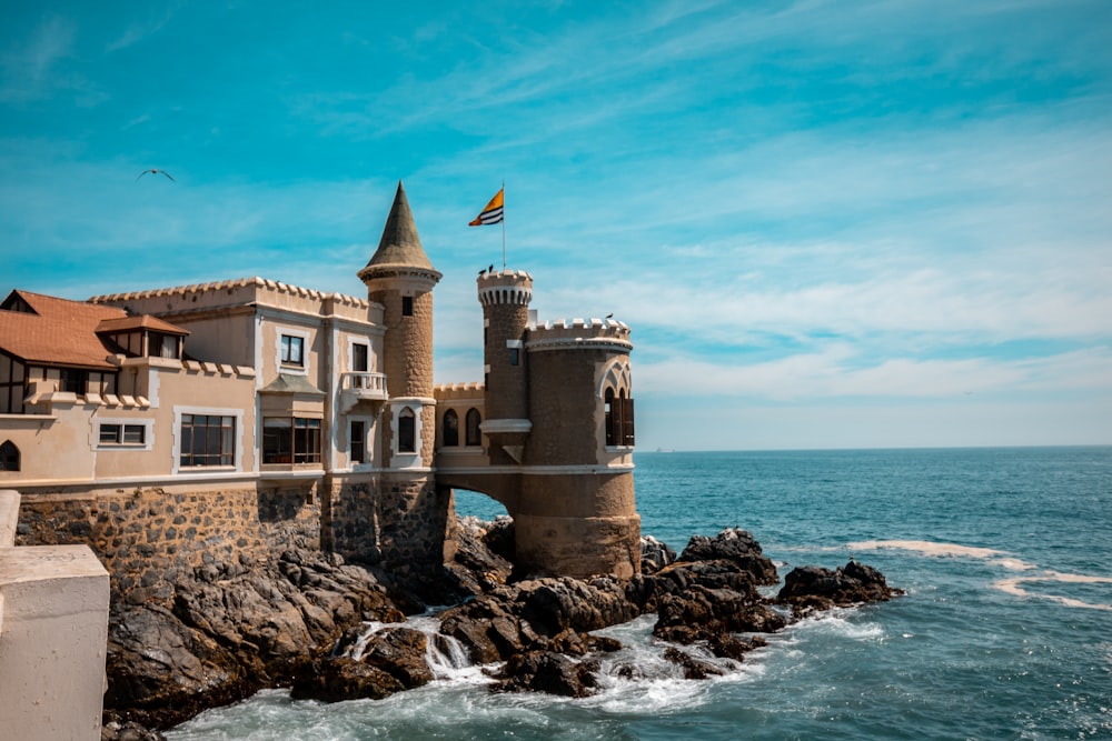 castle beside beach under blue sky