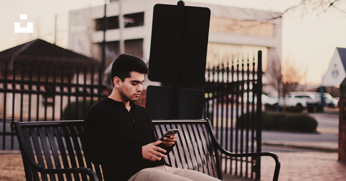 Man sitting on black bench under withered tree photo – Free Beige Image ...