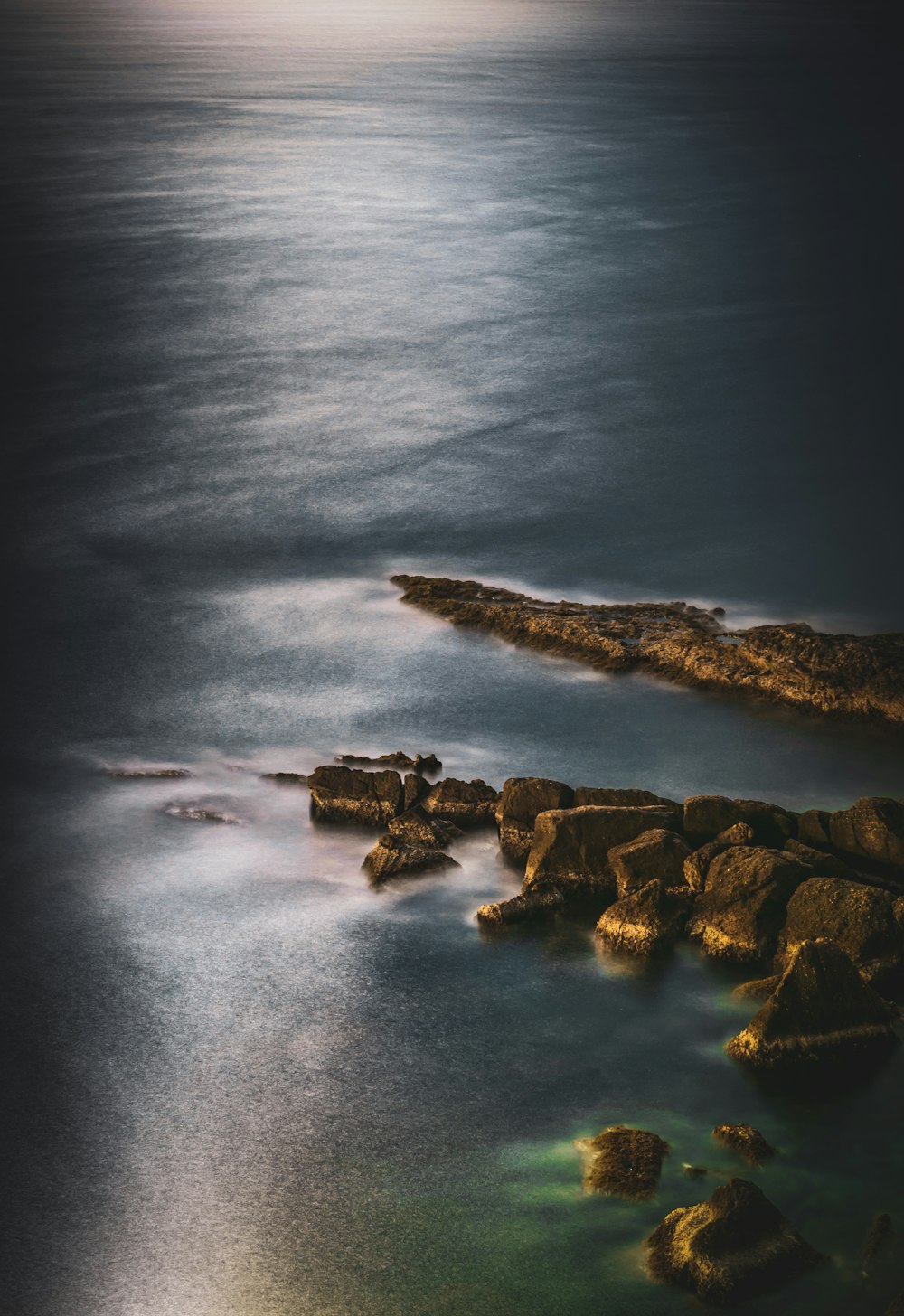 aerial photography of mountain ranges on water during daytime