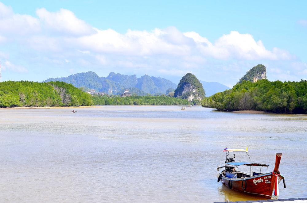 red boat floating on sea side