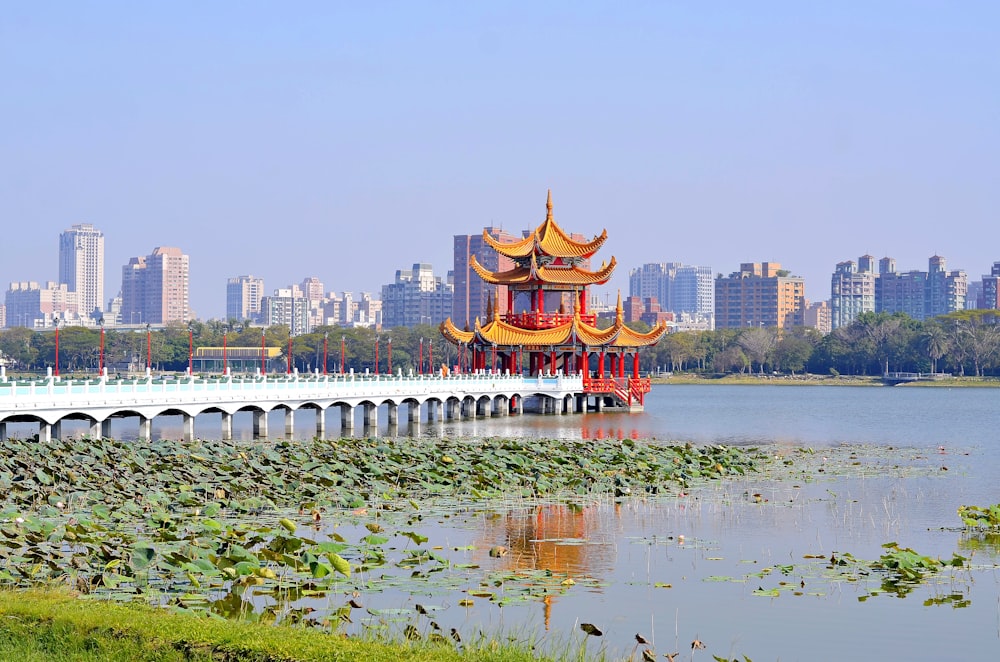 orange pagoda beside beach under clear blue sky