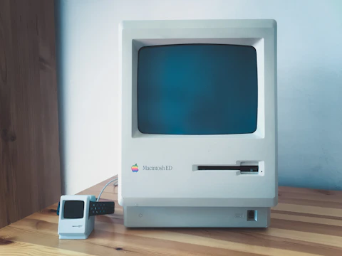 Color photo of a mid-1990s prototype model on a wooden desk.