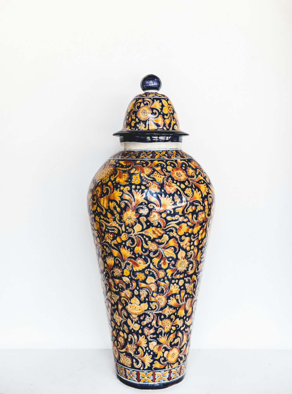 yellow and multicolored ceramic jar