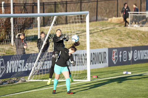 The intense focus of a goalkeeper preparing to stop a penalty kick in a second division match.