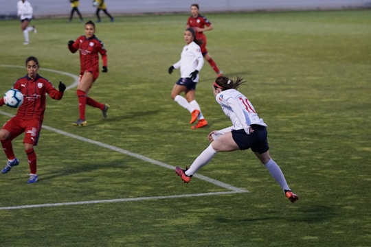 Dynamic shot of a soccer match with Yesenia Hernandez reporting courtside.