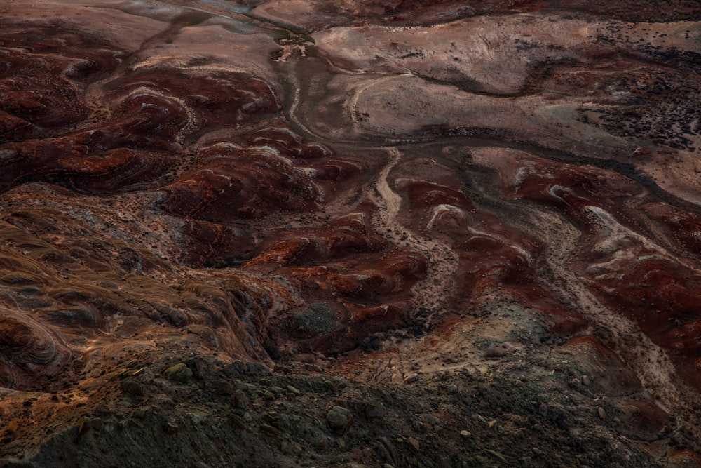 an aerial view of a rocky landscape with a river running through it