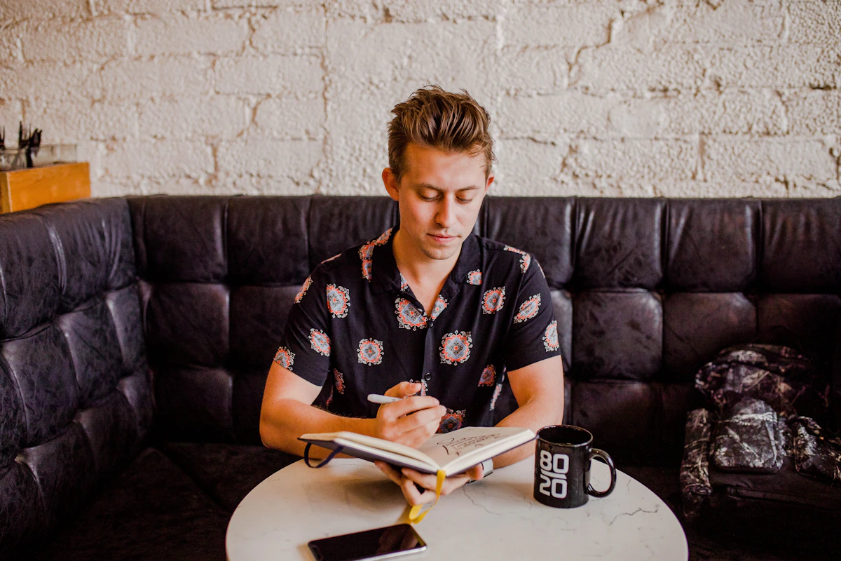 Founder deep in thought at a desk, surrounded by notes and a laptop