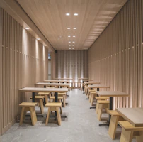 a room filled with wooden tables and benches